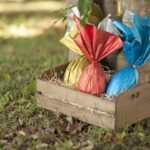 Basket of brazilian Easters eggs under a tree.